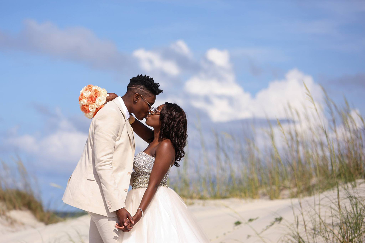 Lesbian Tybee Island elopement with peach and white roses on a perfect day