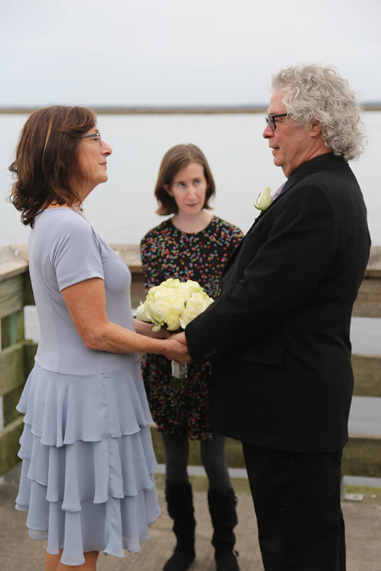 Older couple by the water having an elopement in Savannah